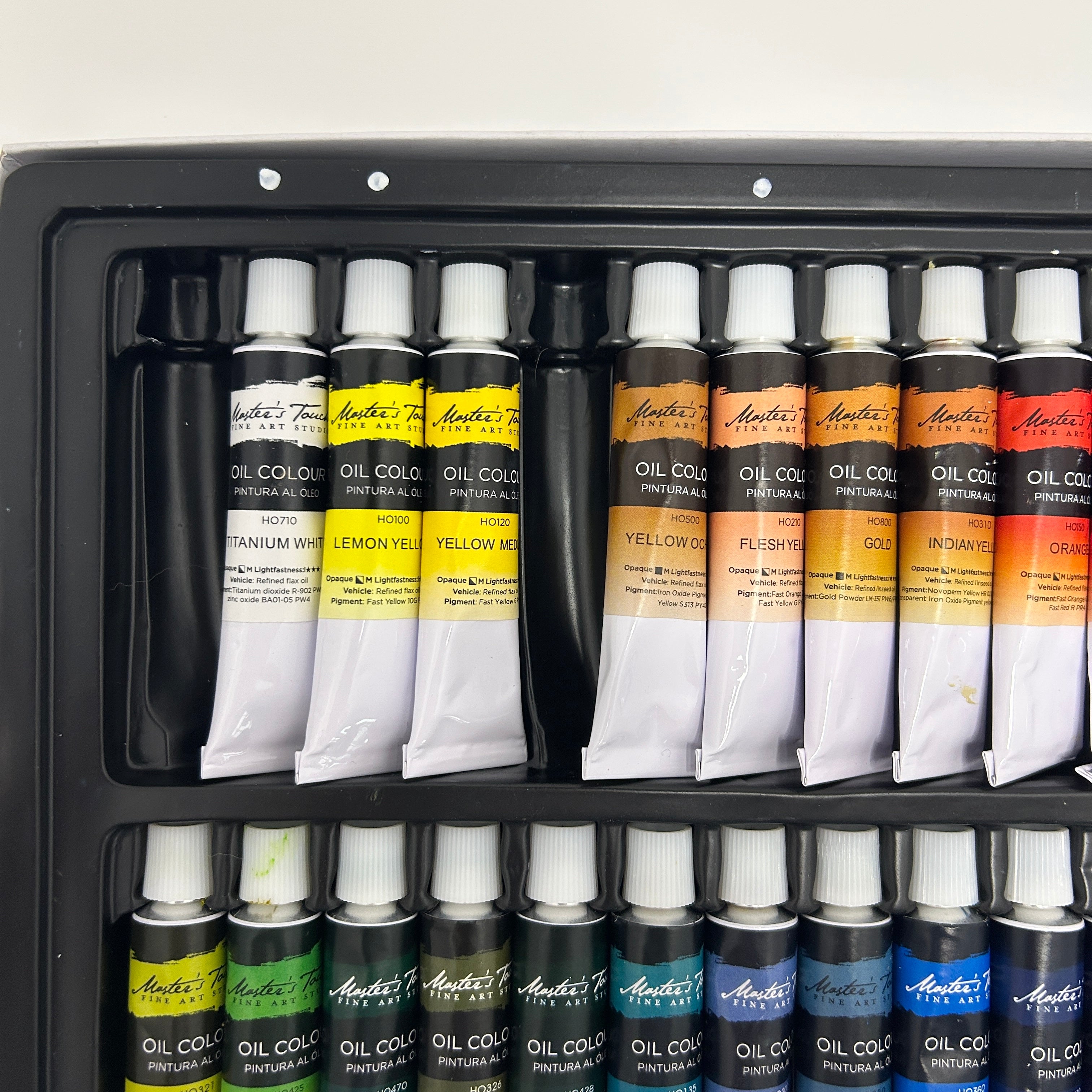 Set of Antoni oil paint tubes in a black storage case.