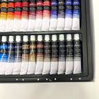 Set of oil paint tubes in a case on a white background